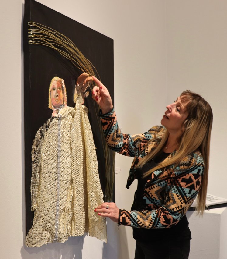 Golden resident Patti Kurtzman observes her work on display at the Reach Studio exhibition. The artist is one of the program’s participants who, while having never experienced homelessness herself, has found her place in the studio’s tight-knit art community.